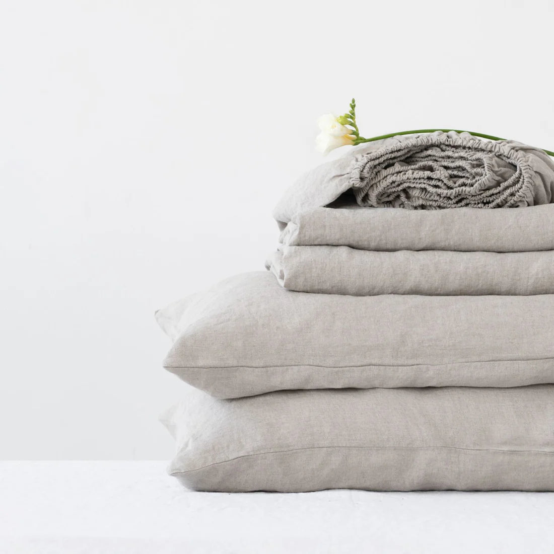 Natural linen sheet set on a beautifully made luxury bed